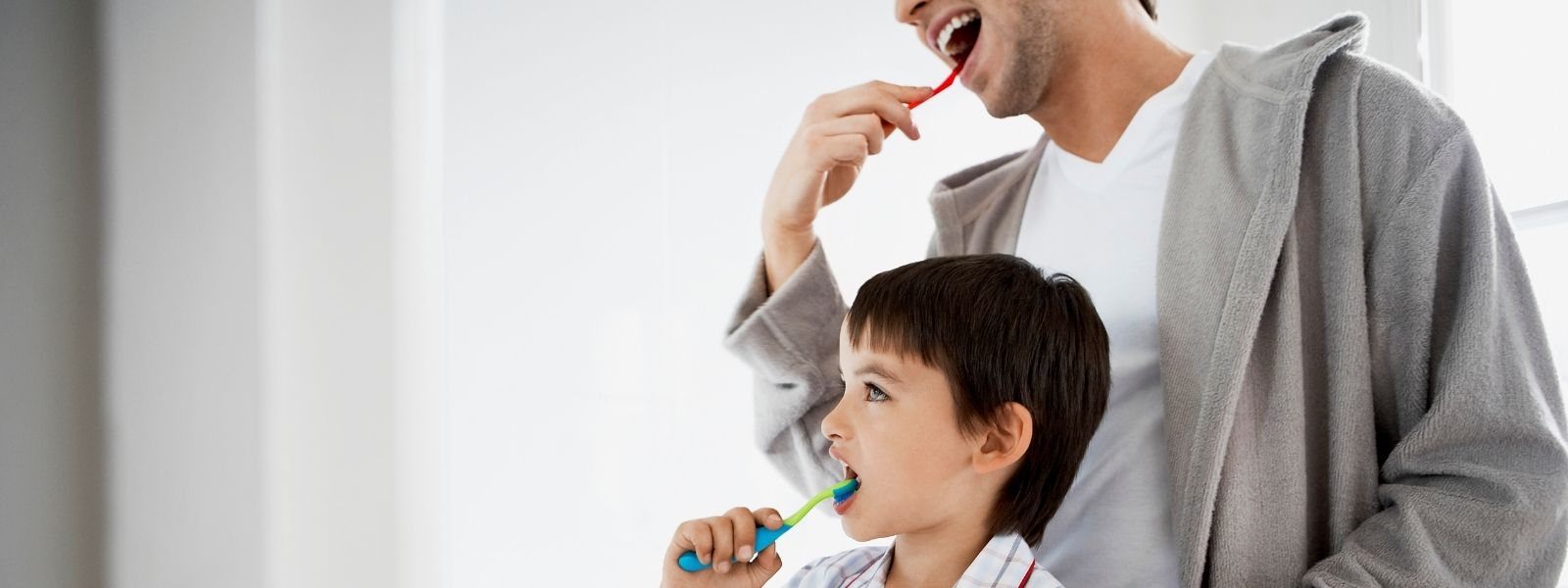 Father and son brushing teeth
